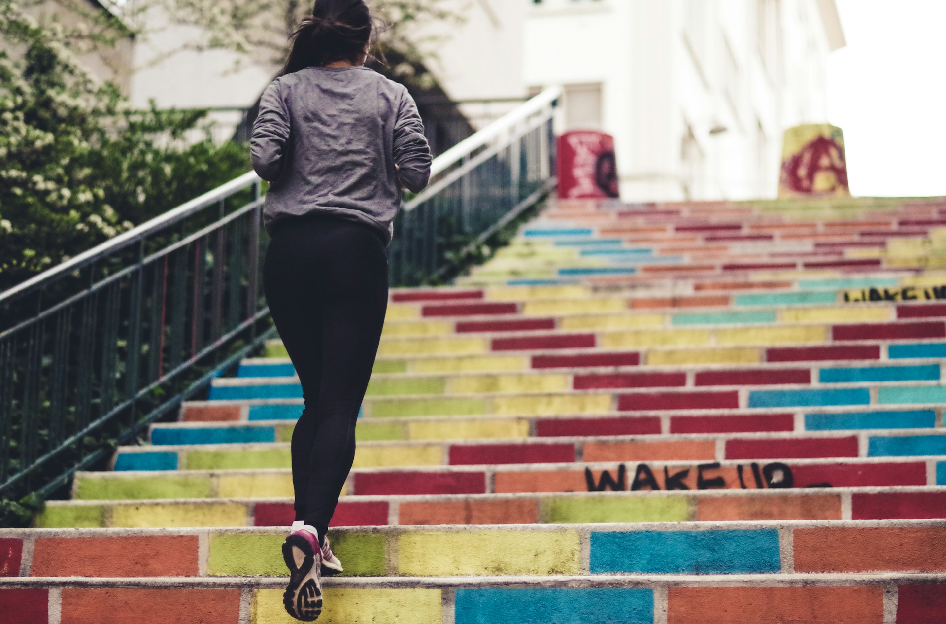Person running up colorful stairs