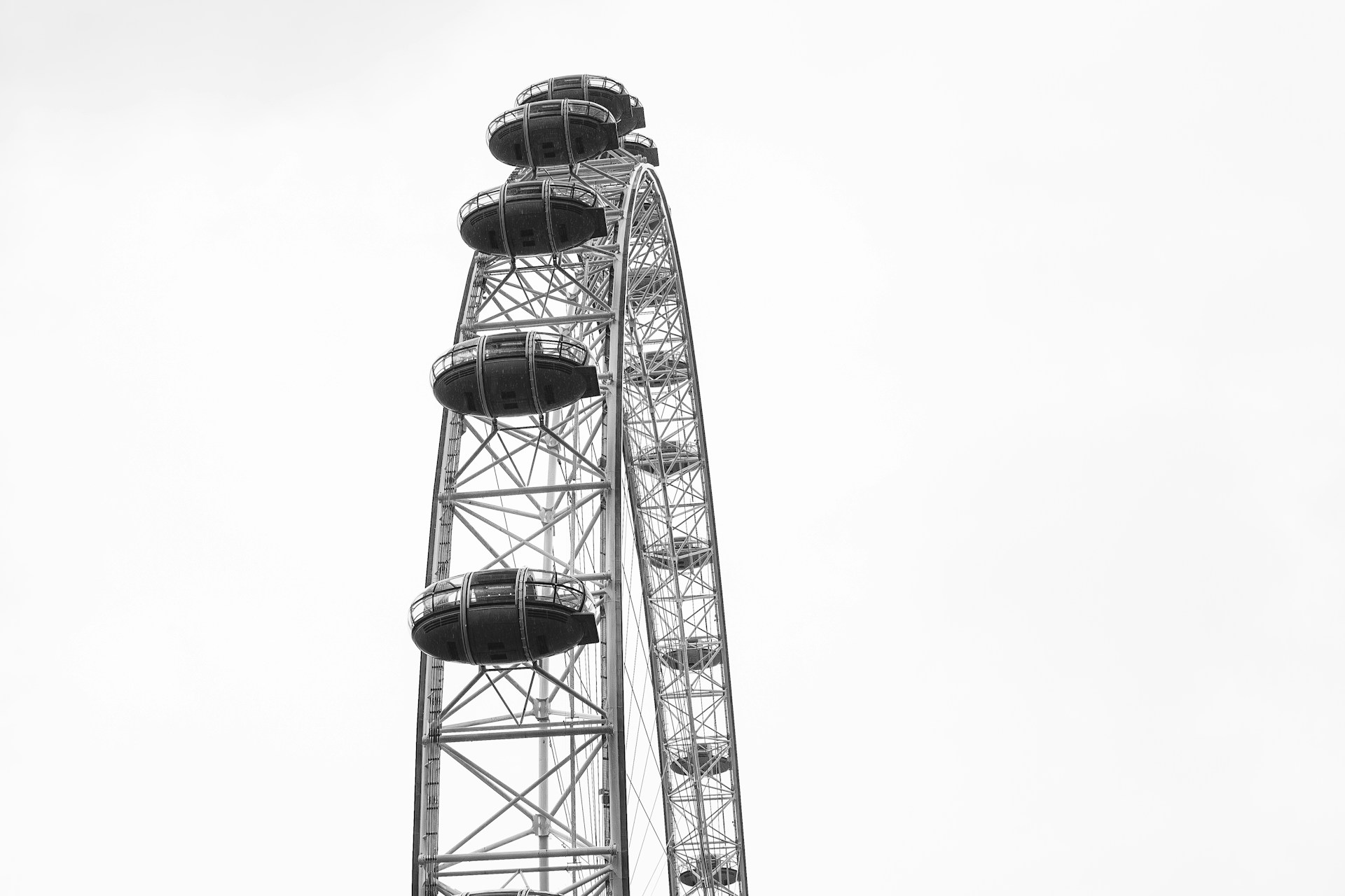 Black and white Ferris wheel close-up shot.