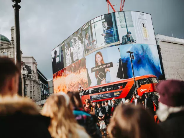 Crowd at Piccadilly Circus, London with billboards.