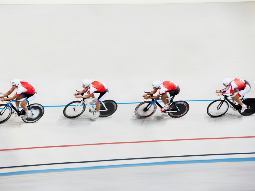 3 Four cyclists racing on a track